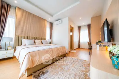 Luxurious bedroom with elegant decor and cozy ambiance, featuring a plush bed and stylish furnishings.