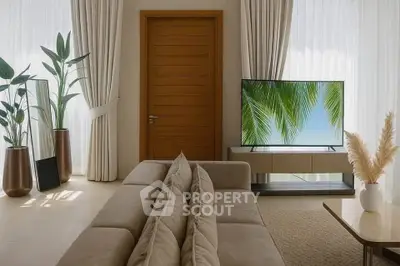 Modern living room with stylish decor and large TV, featuring natural light and elegant furnishings.