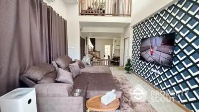 Stylish living room with modern decor and wall-mounted TV in a spacious home