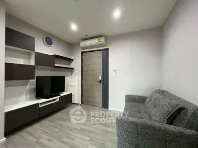 Modern living room with sleek furniture and wall-mounted TV