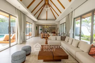 Luxurious open-plan living room with high ceilings and pool view, perfect for entertaining.