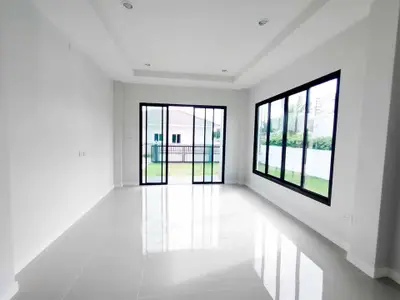 Spacious modern living room with large windows and garden view