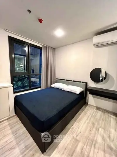 Modern bedroom with large window and stylish decor in urban apartment