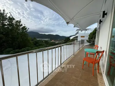 Spacious balcony with stunning mountain views and modern outdoor seating.