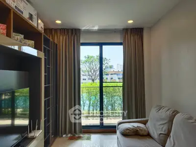 Cozy living room with balcony view, modern decor, and natural light