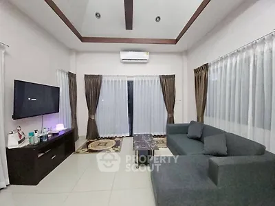 Spacious living room with modern sofa and entertainment setup
