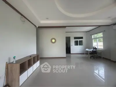 Spacious modern living room with elegant ceiling design and natural light