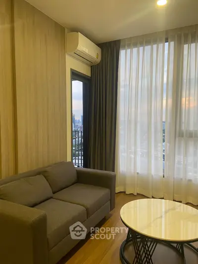 Modern living room with city view, featuring a cozy sofa and elegant coffee table.