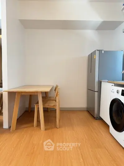 Modern kitchen with wooden dining set and stainless steel appliances