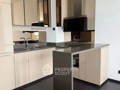 Modern kitchen with sleek cabinetry and island, featuring a minimalist design.