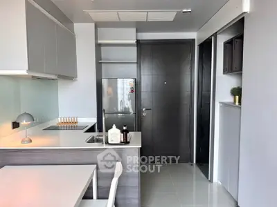 Modern kitchen with sleek design, featuring stainless steel appliances and minimalist decor.