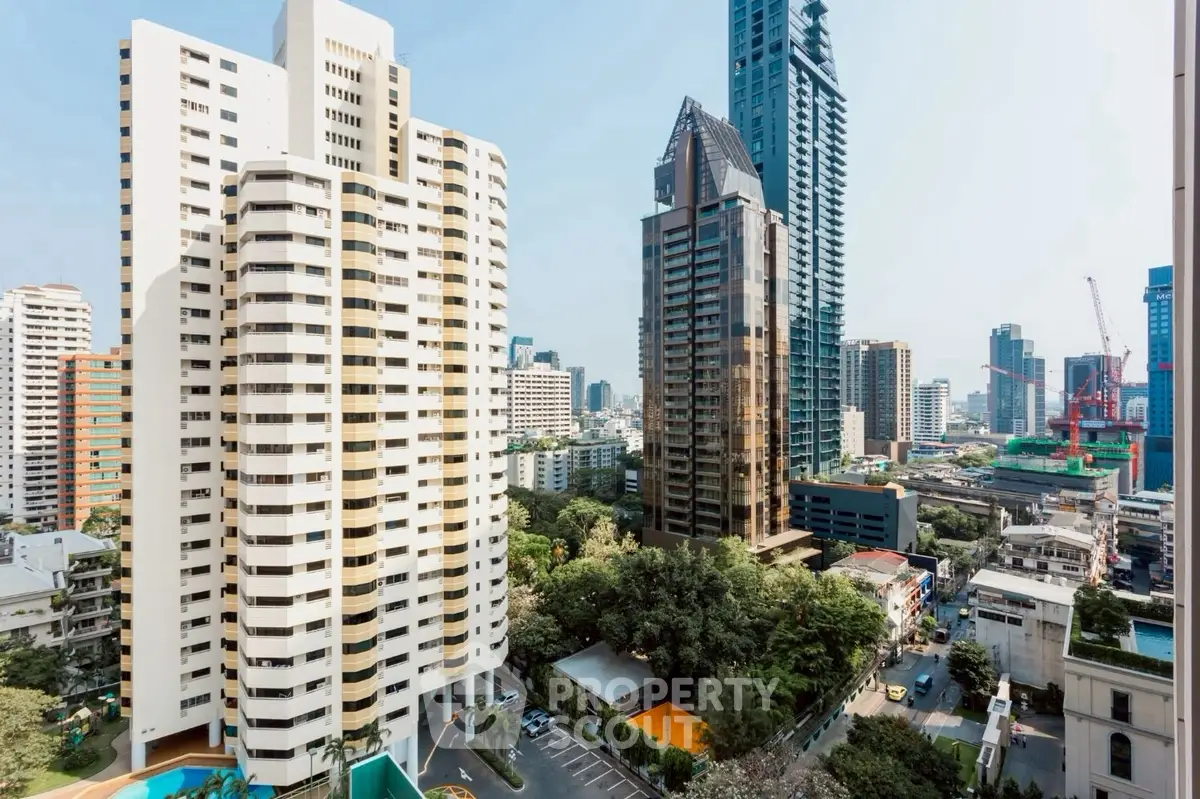 Stunning cityscape view showcasing modern high-rise buildings and lush greenery in urban setting.