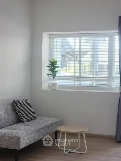 Cozy living room with modern sofa and large window view
