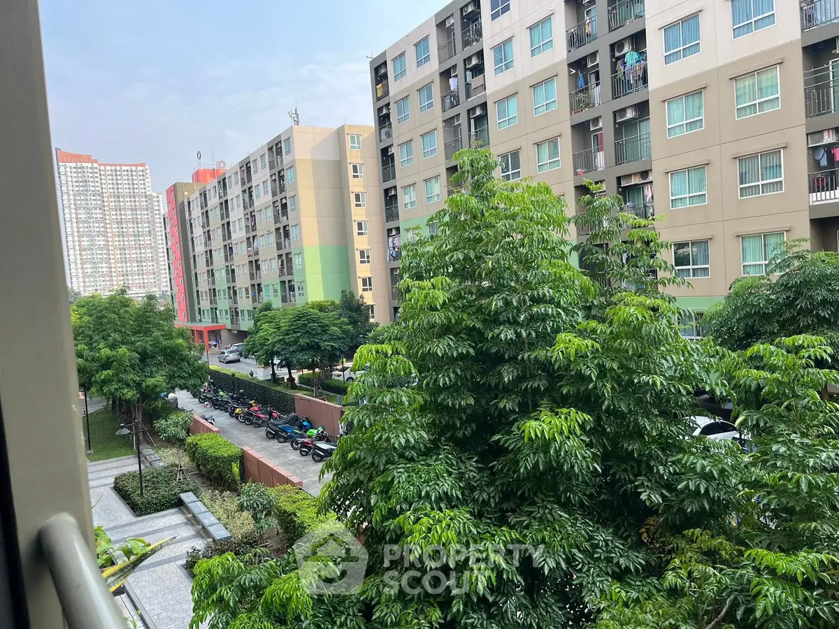 Modern apartment buildings with lush greenery and street view