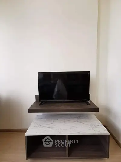Modern living room with sleek TV stand and flat-screen television