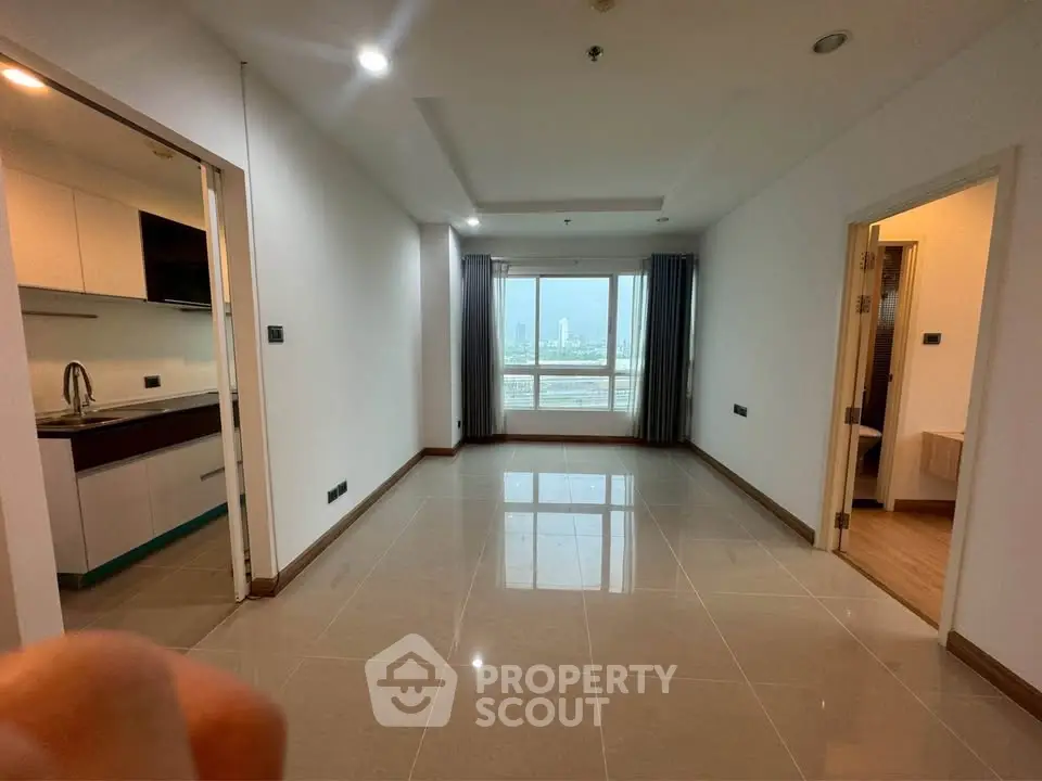 Spacious modern apartment with open layout and city view, featuring sleek kitchen and large windows.
