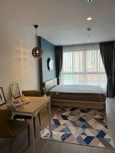 Modern studio apartment with stylish decor and large window view