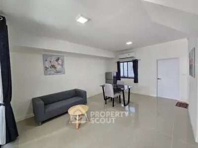 Modern living room with sleek furniture and natural light, perfect for urban living.