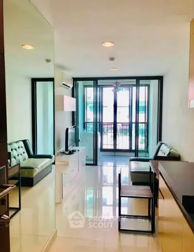 Modern living room with sleek furniture and large windows in a stylish apartment.