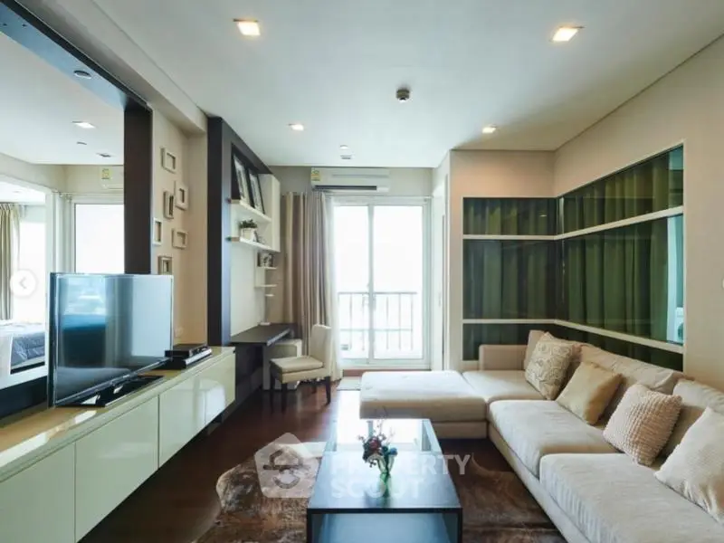 Spacious modern living room with large sofa and natural light