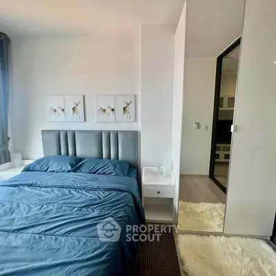 Modern bedroom with stylish decor and cozy blue bedding