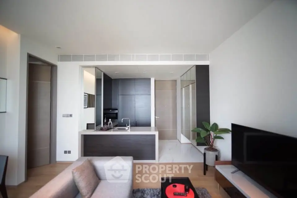 Modern open-layout living room with sleek kitchen and stylish decor