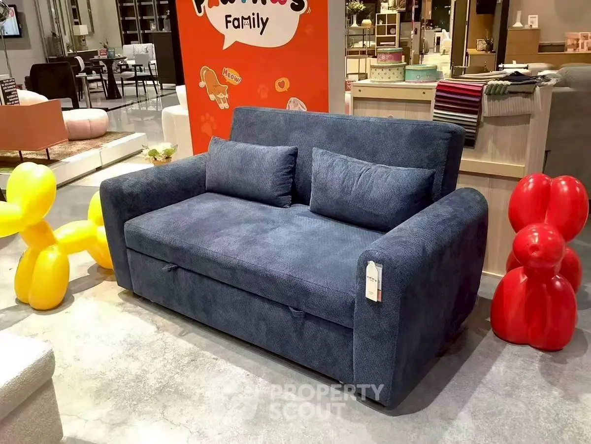 Stylish blue sofa in modern living room with playful decor