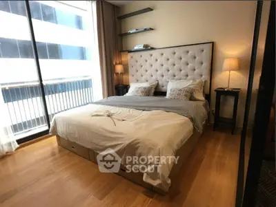 Luxurious bedroom with elegant decor and large windows offering city views.