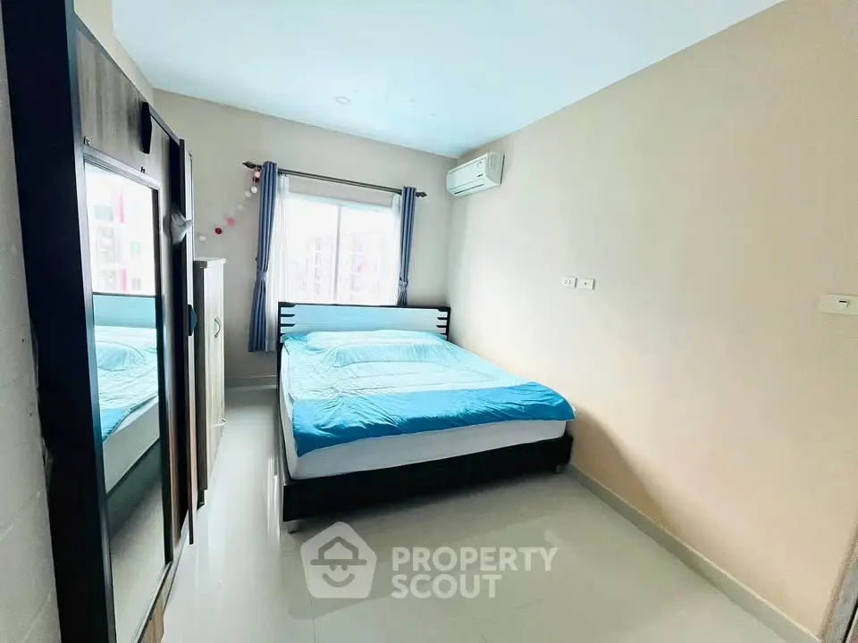 Bright and cozy bedroom with modern furnishings and air conditioning