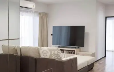 Modern living room with sleek design and large TV, perfect for relaxation and entertainment.