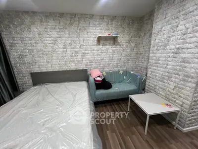 Cozy bedroom with modern decor and stylish brick accent wall