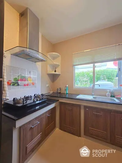 Modern kitchen with gas stove and sleek cabinetry in a bright, airy space.