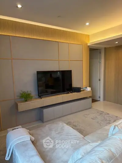 Modern living room with sleek TV setup and cozy seating area
