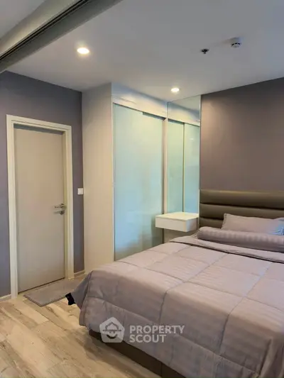 Modern bedroom with sleek design and cozy ambiance, featuring a comfortable bed and stylish decor.