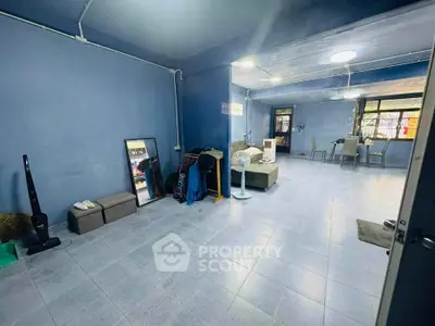 Spacious living room with modern decor and ample natural light, perfect for relaxation and entertainment.