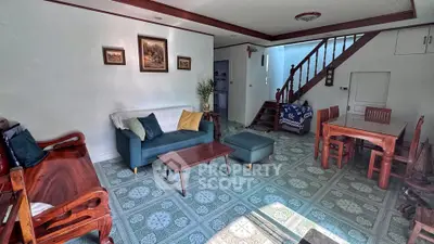 Charming living room with cozy seating and elegant decor, perfect for relaxation and entertaining.