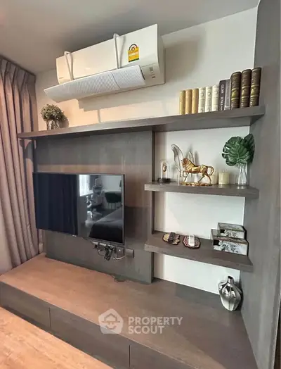 Modern living room with stylish shelving and mounted TV