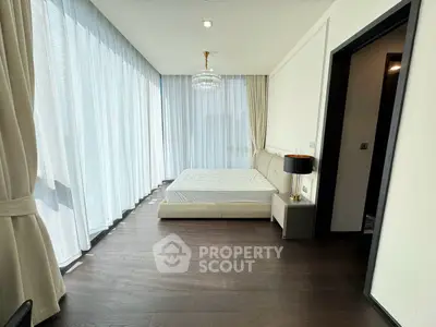 Luxurious bedroom with floor-to-ceiling windows and elegant chandelier