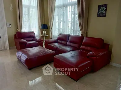 Luxurious living room with red leather sofas and elegant decor