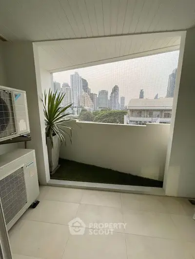 Modern balcony with city skyline view and air conditioning unit