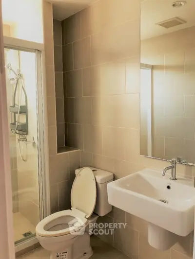 Modern bathroom with shower and sleek fixtures in a contemporary home.