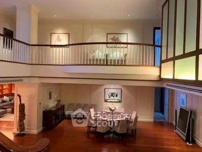 Luxurious open-plan living room with elegant dining area and high ceilings