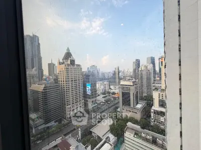 Stunning cityscape view from high-rise building window showcasing urban skyline.