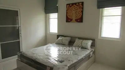 Cozy bedroom with natural light and modern decor in a stylish home.