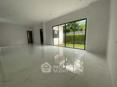 Spacious modern living room with large windows and garden view