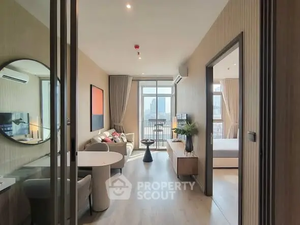 Modern apartment interior with open living room and city view balcony.