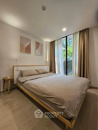 Modern bedroom with large window and stylish decor