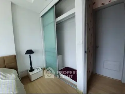 Modern bedroom with sliding closet doors and stylish lamp