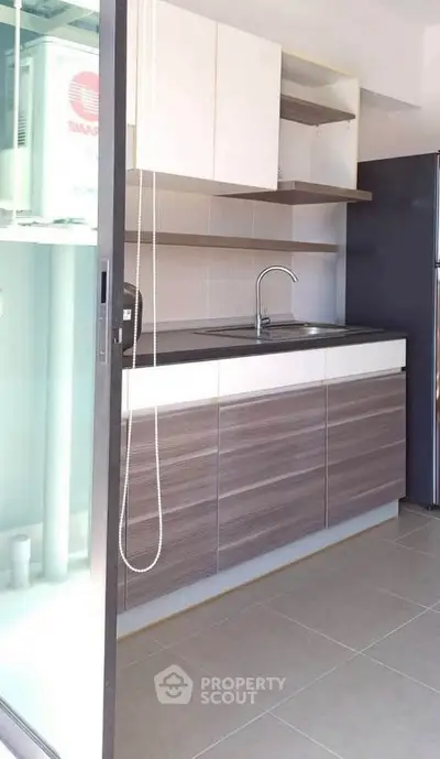 Modern kitchen with sleek cabinetry and stainless steel appliances in a bright, open space.