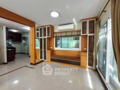 Spacious modern living room with large windows and built-in seating, perfect for natural light lovers.